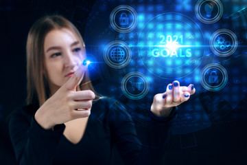 Business, Technology, Internet and network concept. Young businessman working on a virtual screen of the future and sees the inscription: 2021 goals