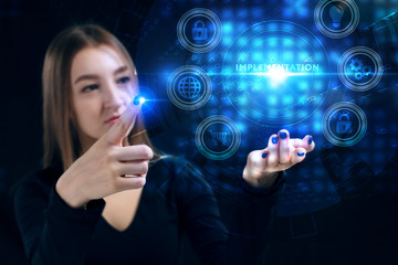 Business, Technology, Internet and network concept. Young businessman working on a virtual screen of the future and sees the inscription: Implementation