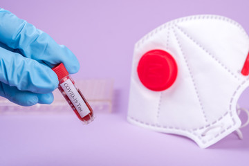 Serum blood with Coronavirus  COVID-19  in test tube in hand of scientist