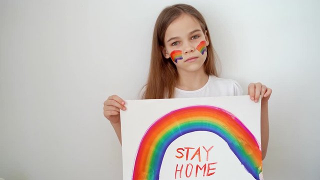 stay home. teen girl drew rainbow and poster.