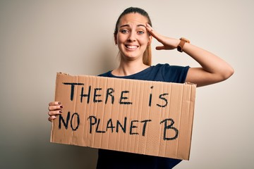 Young beautiful blonde woman with blue eyes asking for protect planet holding banner stressed with hand on head, shocked with shame and surprise face, angry and frustrated. Fear and upset for mistake.