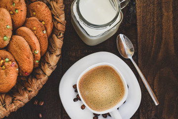 Cup of coffee with cookies and milk