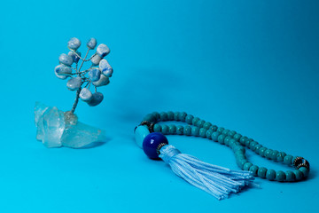 Tree of stones and Small Blue oriental Japa Mala (mala Sanskrit) - Blue background 