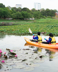 Bangi, Malaysia - Oct 6, 2019: Women kayaking in the Taman Tasik Cempaka lake in the morning.