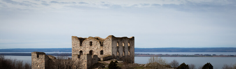 Ruins of the Brahehus Sweden. Free entry. View from the parking lot. Panoramic strip. Lzke Vättern in the background.