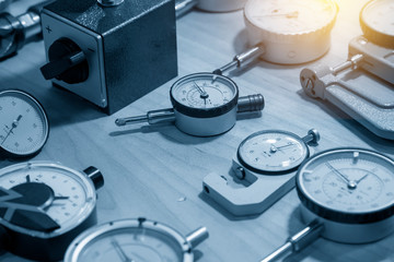 The group of dial indicator gauge on the table with lighting effect. The group of measurement...