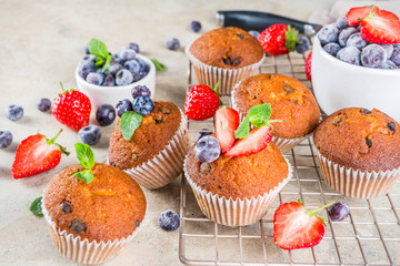 Vanilla muffins or cupcakes with berries