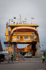 The ferry between Gr&auml;nna and the Island of Visings&ouml; Sweden. Unrecignizable people and registrations plates. Signs in Swedish saying: "Next departure at 02:10 p.m""Dont go onboard without permission"
