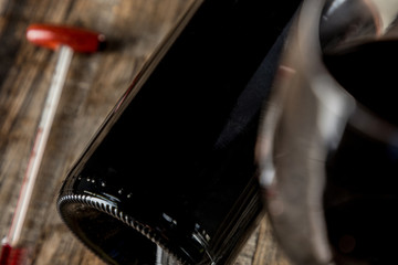 wine bottle with thermometer on wooden table