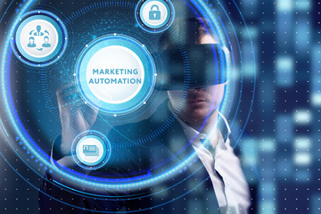 Business, Technology, Internet and network concept. Young businessman working on a virtual screen of the future and sees the inscription: Marketing automation