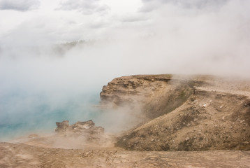 Excelsior Geyser Crater filled with steam and mist in Yellowstone National Park