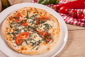 Close up of delicious italian pizza with vegetables & cheese.