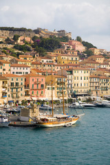 Fototapeta na wymiar Water view of colorful buildings and harbor of Portoferraio, Province of Livorno, on the island of Elba in the Tuscan Archipelago of Italy, Europe, where Napoleon Bonaparte was exiled in 1814
