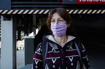 Woman wearing hygienic mask to prevent the Coronavirus. People in masks The outbreak of Novel...