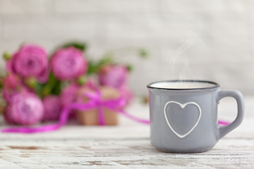 Mother's day concept. Cup of coffee or tea with heart, present and roses copy space.