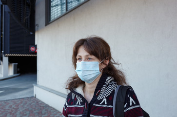Woman wearing hygienic mask to prevent the Coronavirus. People in masks The outbreak of Novel...