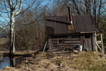
Abandoned hut by a small lake