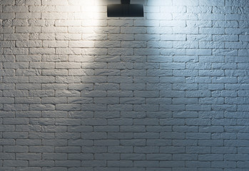 night light from a lamp on an empty white brick wall