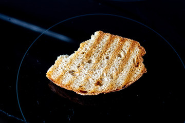 A piece of bread for toast on a dark background