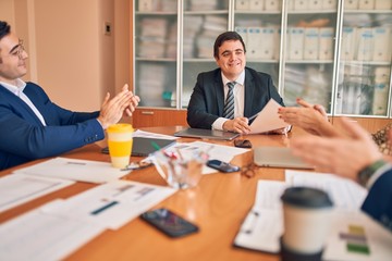 Business lawyers workers meeting at law firm office. Professional executive partners working on finance strategry at the workplace. Clapping to each other for successful achievement.