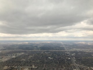 Elevated / aerial view of a residential neighborhood suburbs of Toronto (Ontario, Canada, North America) with townhouses, skyscrapers, transportation system, roads & trees from above