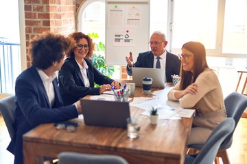 Group of business workers smiling happy and confident. Speaking with smile on face working together at the office.