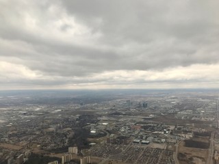 Elevated / aerial view of a residential neighborhood suburbs of Toronto (Ontario, Canada, North America) with townhouses, skyscrapers, transportation system, roads & trees from above