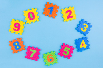 Colorful kids numbers toys on blue background. Place for design. Education concept. Creative concept. Flat lay, copy space, top view.