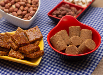 several bowls full of peanuts candies and popcorn