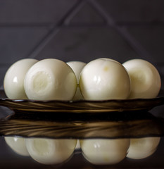 Peeled eggs on a black plate. Hard-boiled eggs. Cooking.