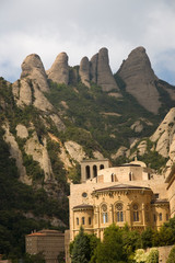 Fototapeta na wymiar The jagged mountains in Catalonia, Spain, showing the Benedictine Abbey at Montserrat, Santa Maria de Montserrat, near Barcelona, where some feel the Holy Grail had been