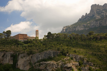 Fototapeta na wymiar The jagged mountains in Catalonia, Spain, showing the Benedictine Abbey at Montserrat, Santa Maria de Montserrat, near Barcelona, where some feel the Holy Grail had been