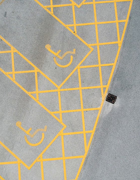 parking bay and disable parking bays from above photographed in an urban setting with a drone. lines and pattern street road markings. straight lines and geometric. drone photography above