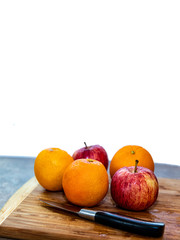 Apples and Oranges on a cutting board