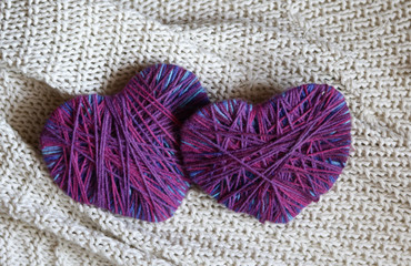 happy Valentines day still life card with woolen yarn thread two hearts copy space on wooden painted board background