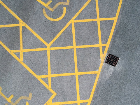 parking bay and disable parking bays from above photographed in an urban setting with a drone. lines and pattern street road markings. straight lines and geometric. drone photography above