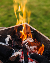 Close-up of grill. Charcoal with fire. Preparation for cooking mixed grill dishes.