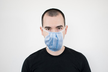 How to Properly Wear a Facemask for COVID-19 Protection. young man stand closeup put on face mask not right. Covidiot.