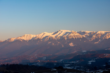 Fototapeta na wymiar sunset on the snowy mountain