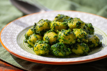 Tasty vegetarian food, italian potato gnocchi with green spinach filled with mozzarella cheese