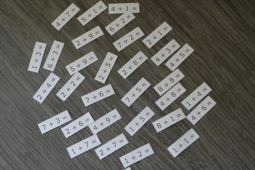 tiles with sums on wooden background