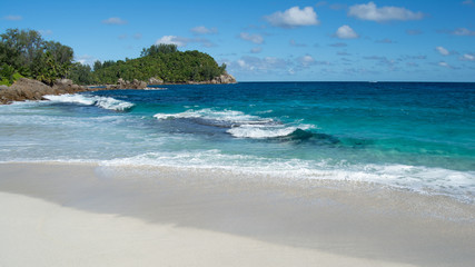 This is a photo taken from a tropical beach on the tropical island of Mahe in Seychelles.  White sandy tropical beach looking out into the Indian Ocean.