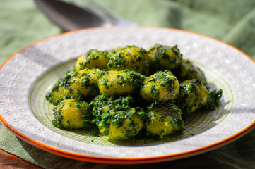 Tasty vegetarian food, italian potato gnocchi with green spinach filled with mozzarella cheese
