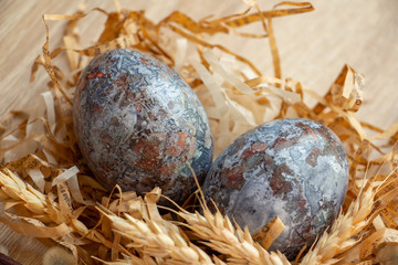 marble blue easter eggs, ears of corn, close up