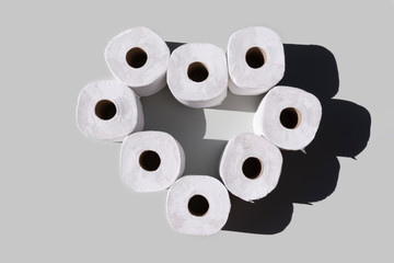 toilet paper rolls on grey background