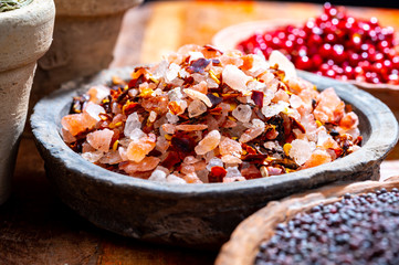 Indian spices collection, sea and rock salt mixed with red hot chili peppers and another spices in clay bowls