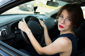 Naklejka na ściany i meble Female in office suit ariives at work by car and need to help