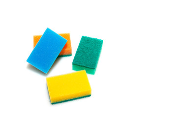 Four sponges of different colors for washing dishes. Isolated object on a white background. Means for cleaning the house.