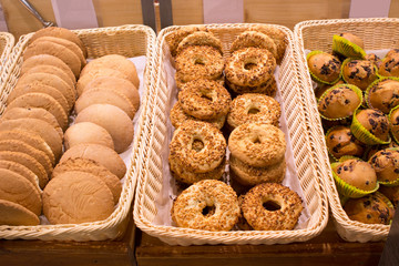 shortbread cookies with peanuts, muffins with raisins, cakes on the counter of a grocery store