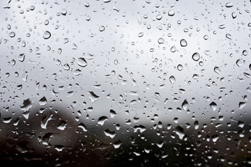 Rain water drops on a window. Moody and sad mood.